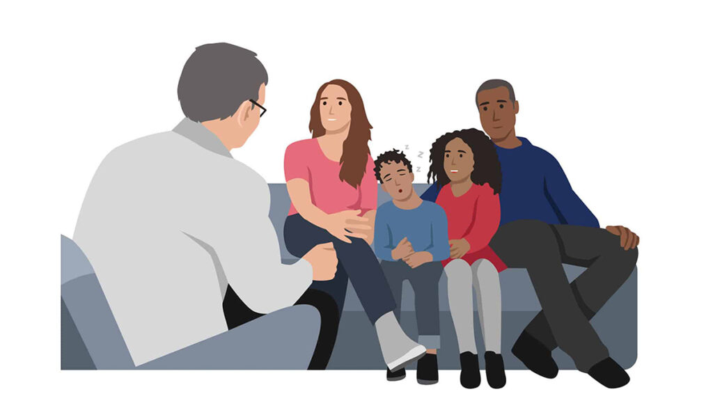 counselor talking with a family that are sitting on a couch